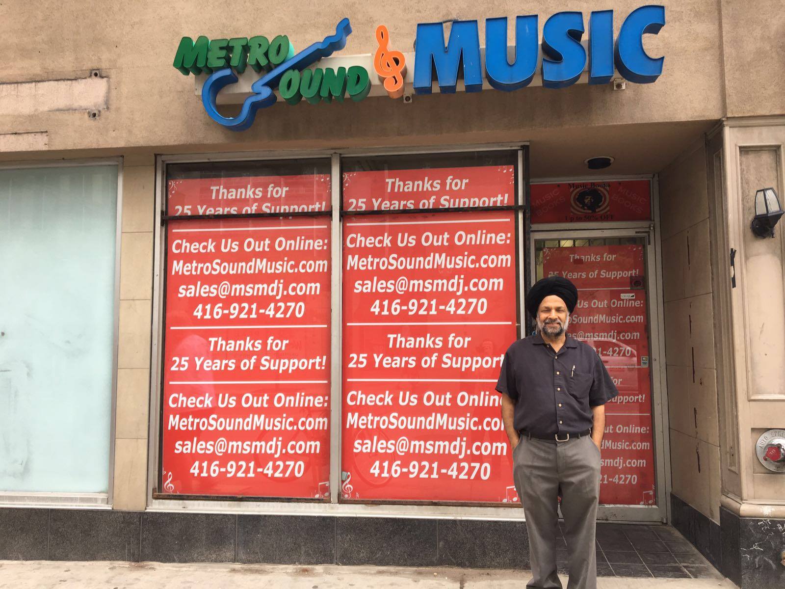 Photo of Metro Sound & Music owner in front of the Toronto store front.