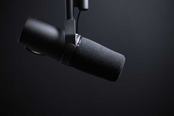 Shure microphone against dark background.