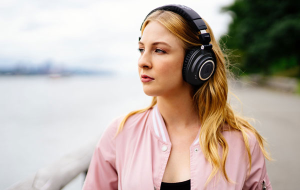 Woman wearing Audio-Technica ATH-M50xBT